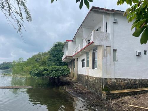 a building sitting in the middle of a river at La Cabaña del Lago in Catemaco