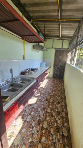 a kitchen with a sink and a tile floor at Baan Suan Resort Doisaket 1 in Ban Tha