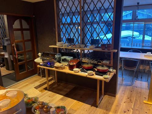 a room with shelves filled with food on a table at Restmance Pension Woody Hill in Iiyama