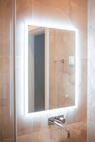 a mirror above a sink in a bathroom at Casablanca Boutique Bed&Breakfast in Zagreb
