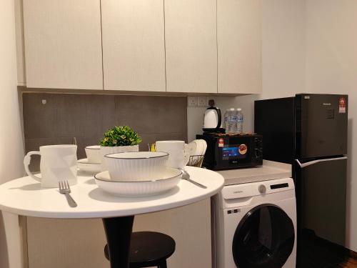 a kitchen with a table with dishes on it at Near Airport K Avenue Family Room in Donggongon