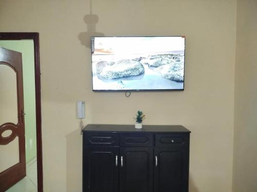 a flat screen tv hanging on a wall at luxury apartment Ryad zitoune in Meknès