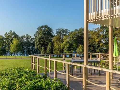 a wooden boardwalk in a park with a picnic table at Tranquil Villa for 8 Guests in Boussu-lez-Walcourt