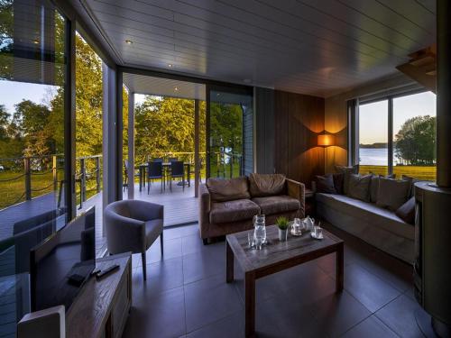 a living room with a couch and a table at Tranquil Villa for 8 Guests in Boussu-lez-Walcourt