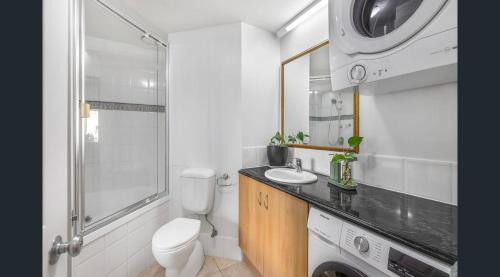 a bathroom with a toilet and a sink and a shower at Landmark Resort Private Apartment in Mooloolaba