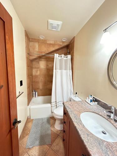 a bathroom with a sink and a toilet and a tub at Studio- Steps from Stanford & Close to Everything! in Palo Alto