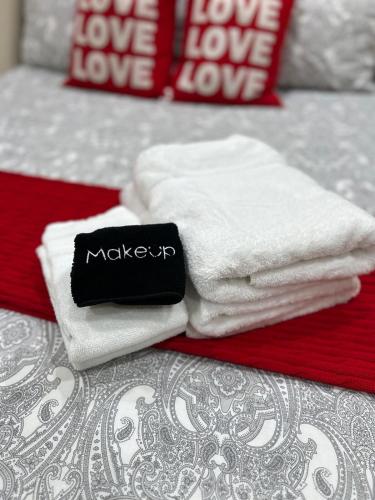 a pile of towels sitting on top of a bed at Studio- Steps from Stanford & Close to Everything! in Palo Alto
