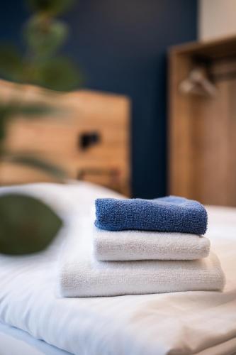 a stack of towels sitting on top of a bed at Casablanca Boutique Bed&Breakfast in Zagreb