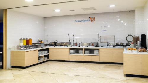 a large kitchen with a counter in a restaurant at Holiday Inn Express Mexico Santa Fe by IHG in Mexico City