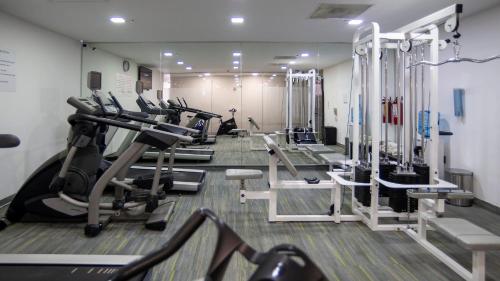 a gym with rows of treadmills and elliptical machines at Holiday Inn Express Mexico Santa Fe by IHG in Mexico City