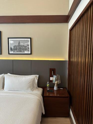 a bedroom with a bed and a table with a night stand at Holiday Inn Santo Domingo by IHG in Santo Domingo