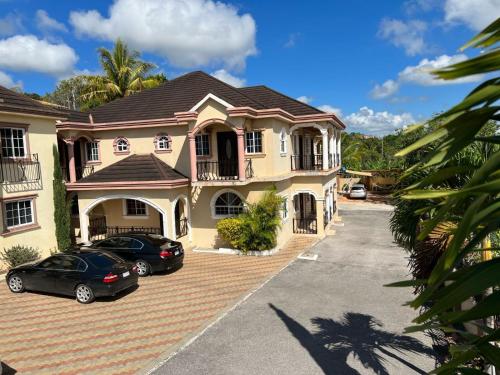 a house with two cars parked in a parking lot at Mandeville Vacation Home in Mandeville