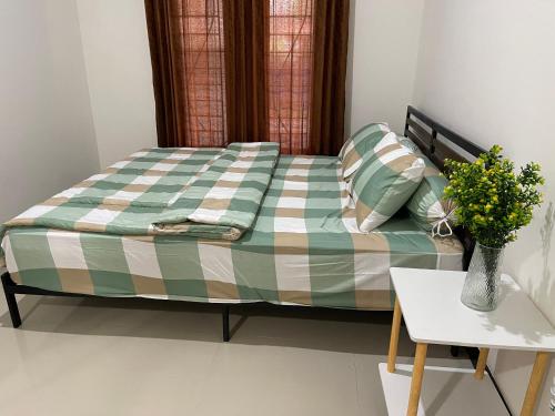 a bed in a room with a vase on a table at Rdk Homestay in Jarakan