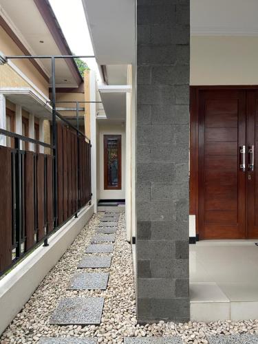 a hallway of a house with a stone walkway at Rdk Homestay in Jarakan