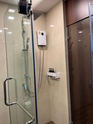 a shower with a glass door in a bathroom at A303Forestkhaoyai in Ban Huai Sok Noi