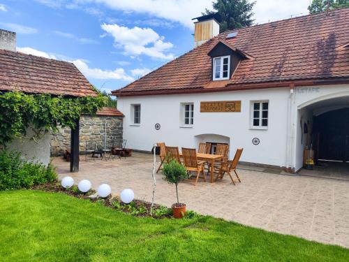 a house with a patio and a table and chairs at Statek Napořád in Předslavice