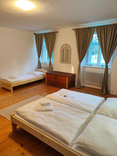 a bedroom with two large beds and a window at Statek Napořád in Předslavice