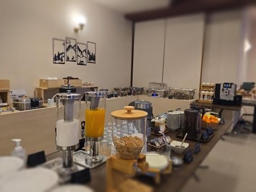 a table with some food and drinks on it at Hotel Cerulean Alpine in Otari