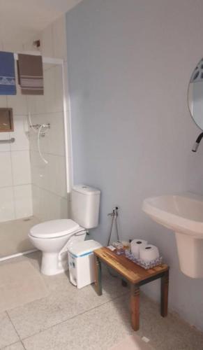 a bathroom with a toilet and a sink at Pousada Maria Moura in Camacari