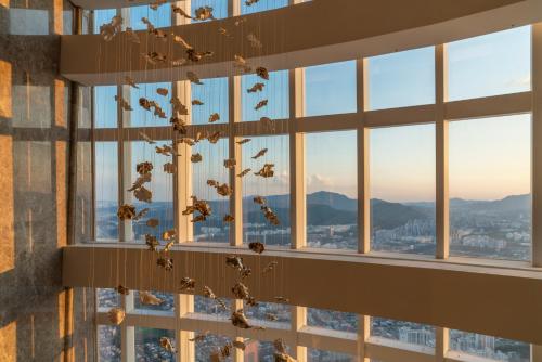 a group of birds flying in a building at Signiel Seoul in Seoul