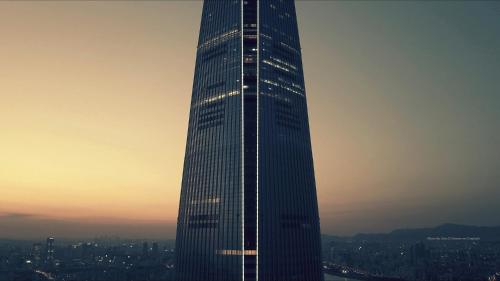 a tall skyscraper in a city at sunset at Signiel Seoul in Seoul