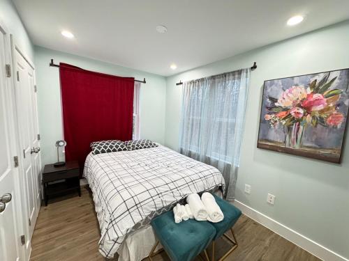 a small bedroom with a bed and a red curtain at Beautiful Cozy Home in DC with Easy Parking in Washington