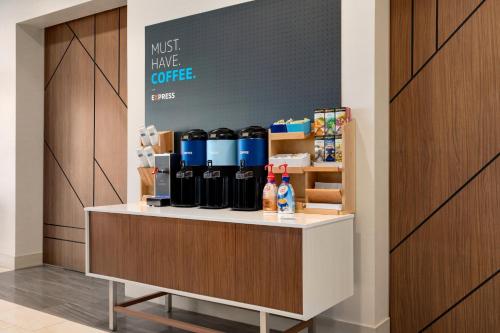 a counter with a bunch of bottles of wine at Holiday Inn Express & Suites - Dalton - Walnut Ave by IHG in Dalton