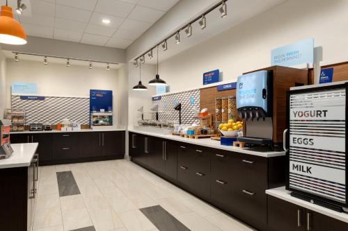 a kitchen with black cabinets and a counter at Holiday Inn Express & Suites - Dalton - Walnut Ave by IHG in Dalton