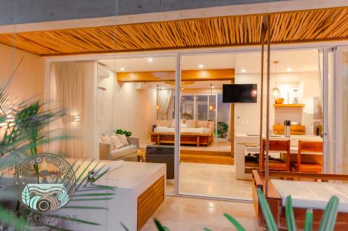 a living room with a couch and a dining room at New 1BR with Jacuzzi & Free Access to Akna Beach Club in Tulum