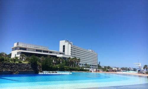 a building on the beach with a large swimming pool at Oiso Prince Hotel in Oiso