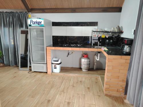 a kitchen with a table and a counter top at Cabaña Falda del Volcán Barú Planta baja in Paso Ancho