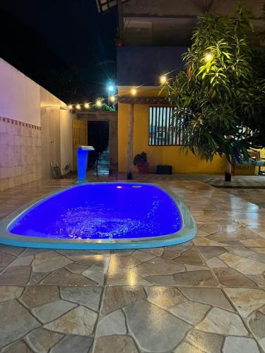 a large blue fountain in a courtyard at night at Pousada Maria Moura in Camacari