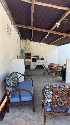 a living room with a couch and a fireplace at Pousada Maria Moura in Camacari