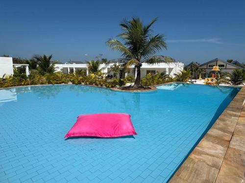 a large swimming pool with a pink pillow on it at You&Me Resort in Koh Rong Island