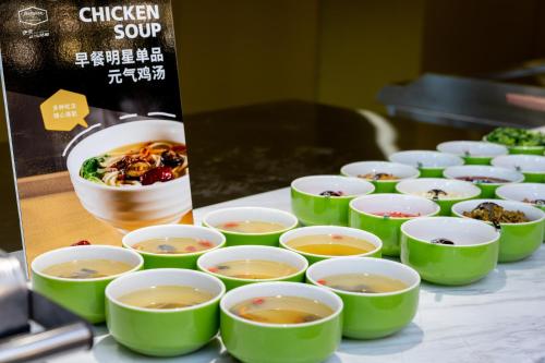 a group of bowls of soup on a table at Hampton by Hilton Zhangjiajie Tianmen Mountain in Zhangjiajie