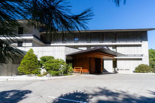 a building with a wooden entrance to a courtyard at Chalet Ivy Jozankei in Jozankei