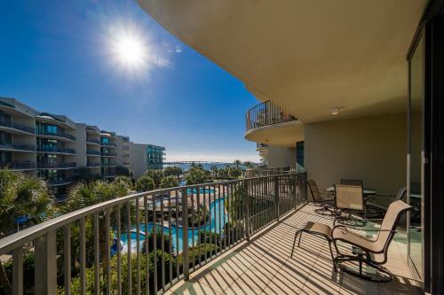 a balcony with chairs and a swimming pool at Phoenix on the Bay 1314 condo in Orange Beach