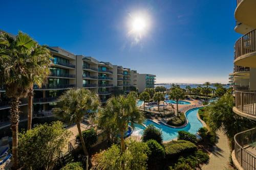 an aerial view of a resort with a pool and palm trees at Phoenix on the Bay 1314 condo in Orange Beach