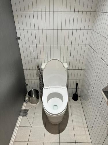 a bathroom with a white toilet in a stall at DADU House in Seoul