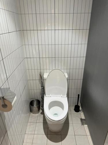 a bathroom with a white toilet in a stall at DADU House in Seoul