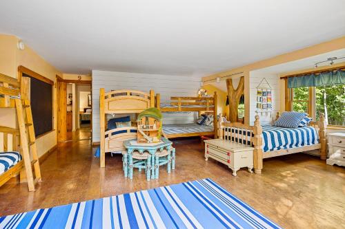 a bedroom with two bunk beds and a living room at The Pine Lodge in Northport