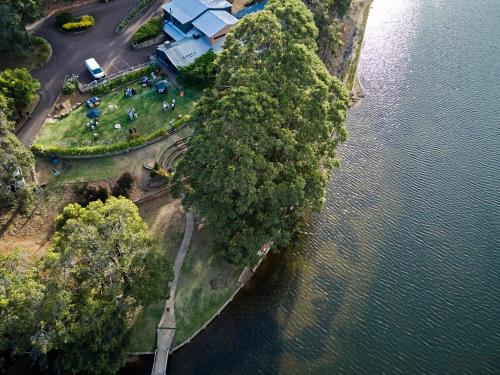 an aerial view of a group of trees next to the water at Evedon Lakeside Retreat in Burekup