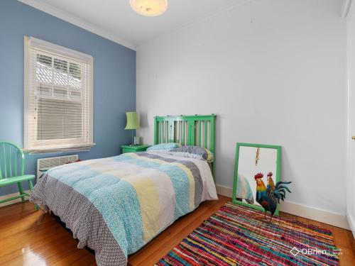 a bedroom with a bed and a rug at Ventnor Coastal Charm in Ventnor