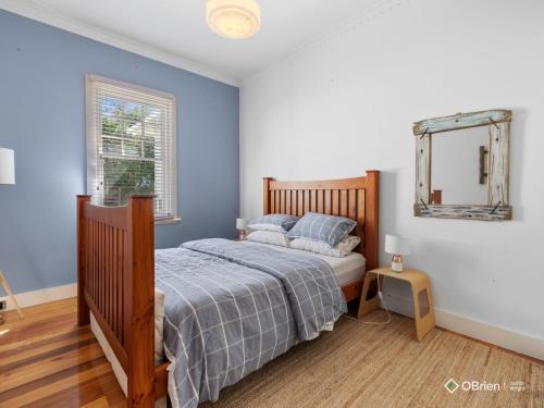 a bedroom with a bed and a mirror on the wall at Ventnor Coastal Charm in Ventnor