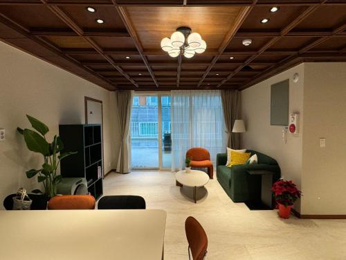 a living room with a couch and a table at DADU House in Seoul