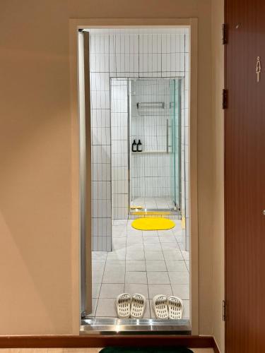 a view of a bathroom with a shower through a glass door at DADU House in Seoul