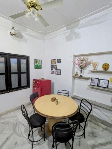 a dining room with a table and chairs at Punia's Staycation in Udaipur