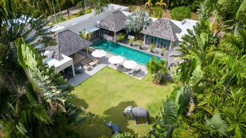 an aerial view of a house with an elephant in the yard at Luxury 3BR Villa C Layan Estate, Idyllic Retreat near Beach in Layan Beach