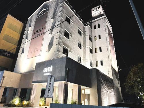 a tall building with a sign on the side of it at Hotel Ami in Gwangju