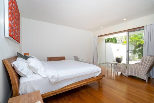 a bedroom with a bed and a large window at Luxury 3BR Villa C Layan Estate, Idyllic Retreat near Beach in Layan Beach